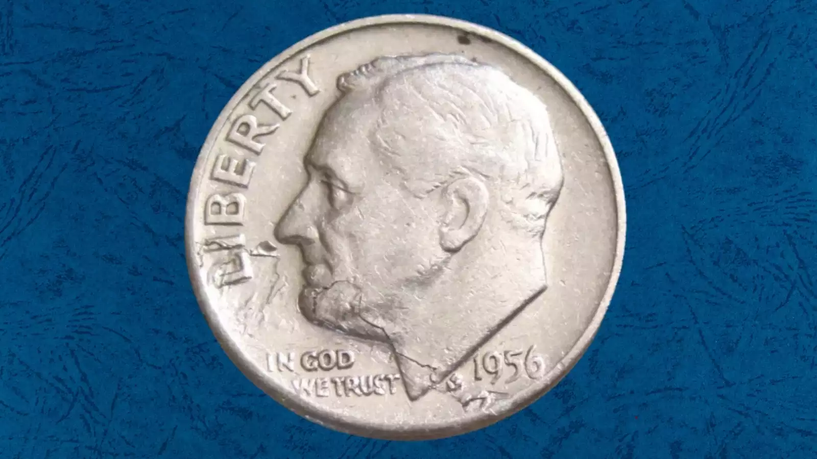 1956 Roosevelt dime lamination error showing peeling or cracked silver surface layer